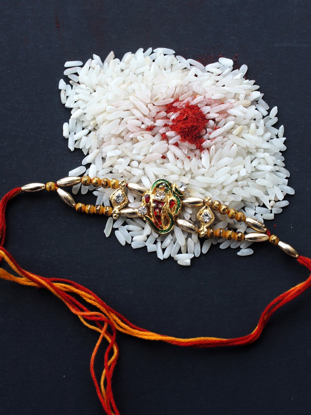 Metallic-ganesha-on-om-Rakhi Metallic-ganesha-on-om-Rakhi