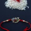 Metallick-peacock-with-crystals-rakhi